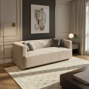 Beige sofa with gray cushions in a luxe living room featuring a dark accent wall, abstract artwork, gold floor lamp, and side table by a window.