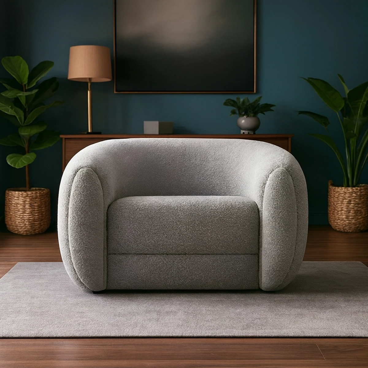 Rounded gray boucle armchair on a light rug in a modern living room with teal walls and potted plants.