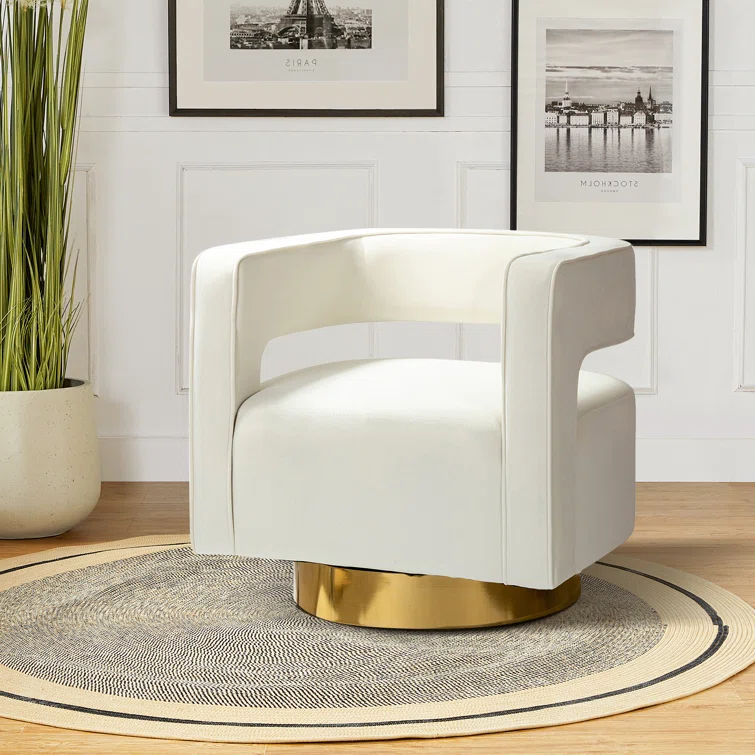 White upholstered armchair with a gold circular base sits on a round rug in a bright, modern living room.