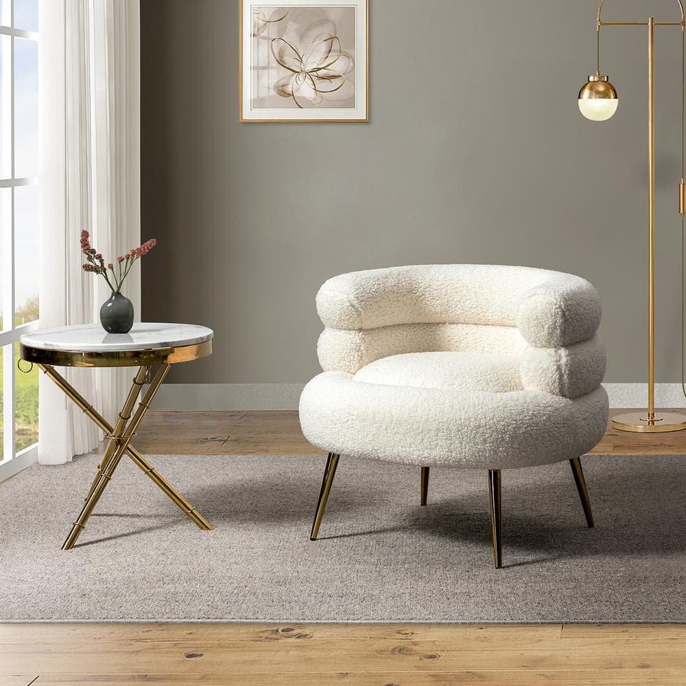 Cozy modern living room corner with a white boucle armchair, round marble side table, and gold floor lamp.